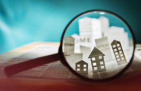 Buildings seen through magnifying glass.